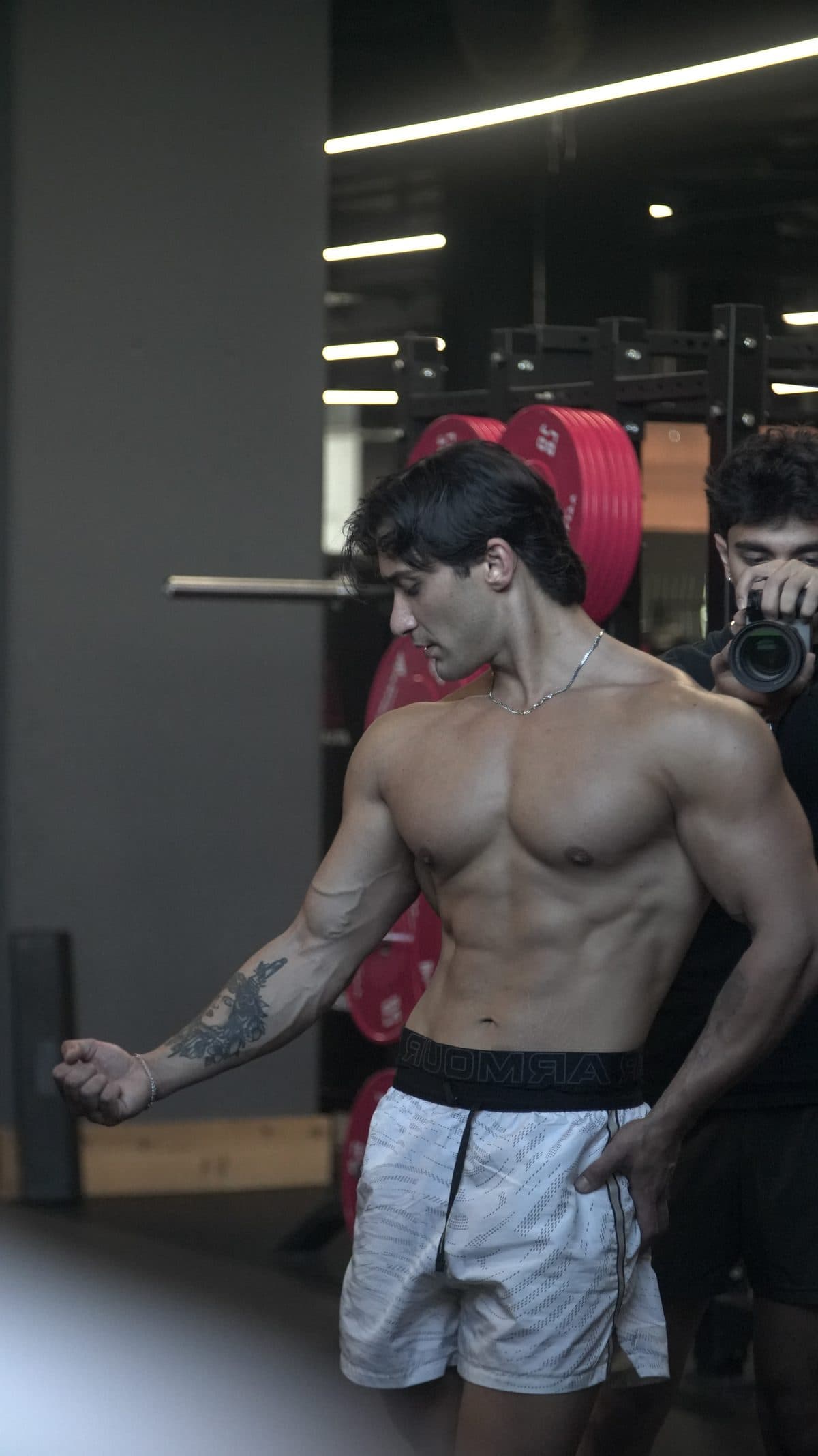 Celal flexing between sets during a photo shoot